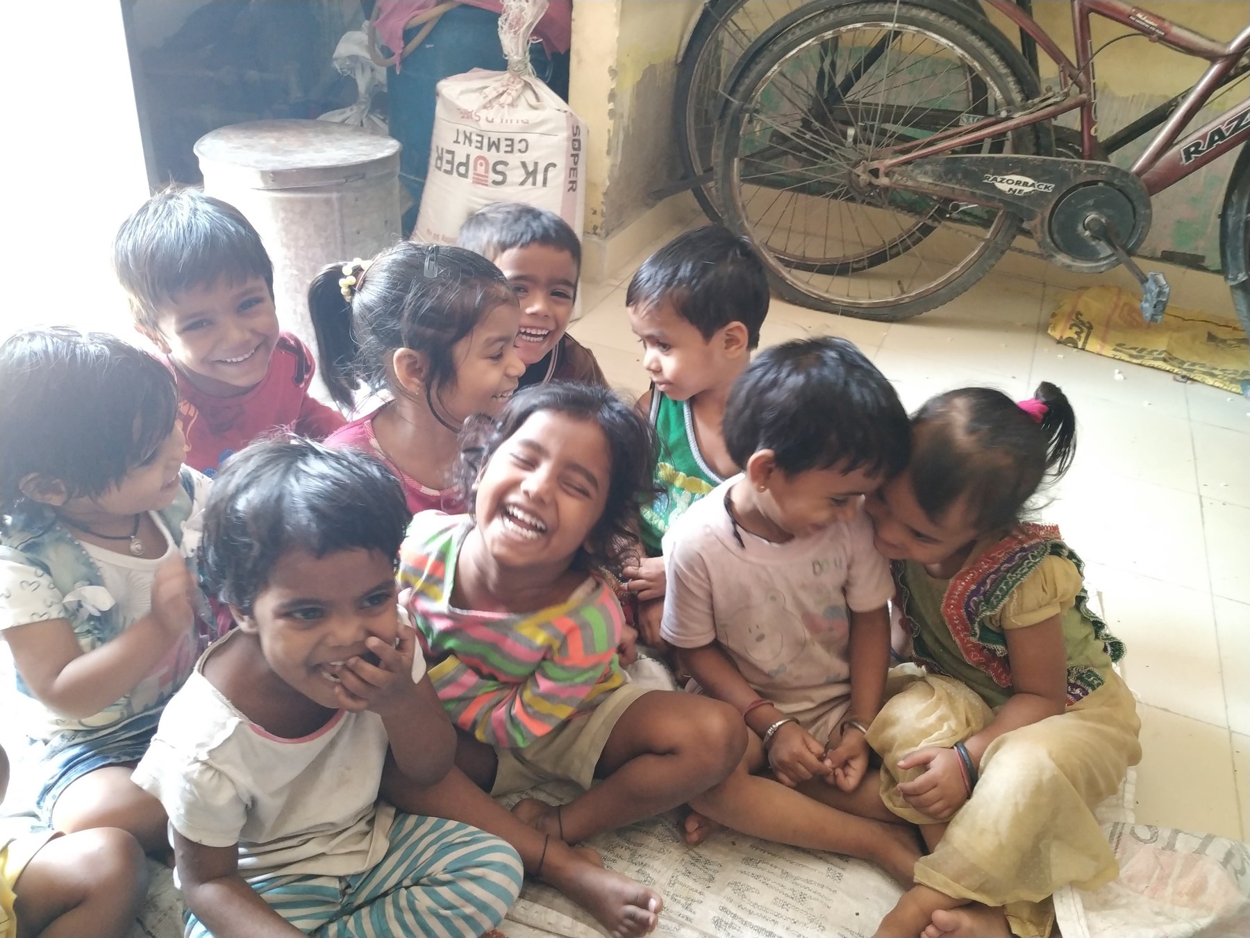 Children sharing a joyful moment at a Santhusta learning space